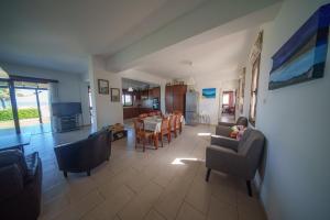 a living room with chairs and a dining room at Ocean Breeze Club-Villa Mare in Kato Yialia