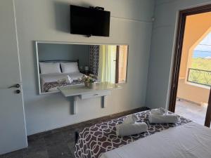 a bedroom with a large mirror and a bed at Loukia's apartment no 2 in Mesochórion