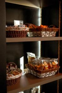 a shelf with baskets of bread and other food at Hotel Tupinambá Timon in Timon