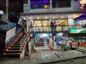 a building with stairs and people standing on a balcony at DAS HOTEL in Darjeeling