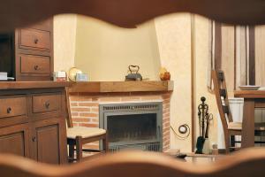 a living room with a brick fireplace with a chair at Family Apartment with Mountain View in Hueva in Hueva +4 photos