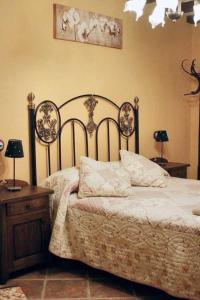 a bedroom with a bed and two tables and two lamps at Family Apartment with Mountain View in Hueva in Hueva