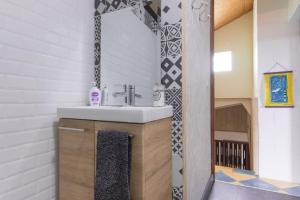 a bathroom with a sink and a mirror at Villa élégante à Saint-Paul avec piscine privée ouverte toute l'année in Saint-Paul
