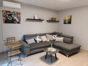 a living room with a couch and a table at By the Center in Balatonalmádi