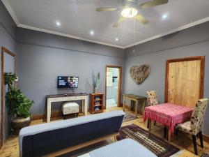 a living room with a couch and a table at GreenMarket Apartment in Knysna