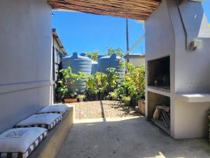 a patio with three pillows and a tv on a building at GreenMarket Apartment in Knysna
