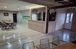 a restaurant with a table and chairs in a room at Hotel Opalchenets Стаи за гости и парти зала in Shipka