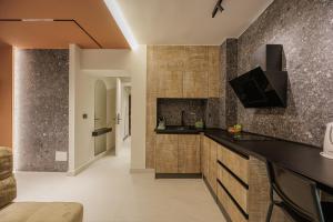 a kitchen with a black counter top and wooden cabinets at Dreamscape Central in Tirana
