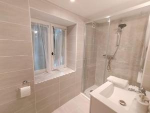 a bathroom with a shower and a sink at Kinvara Gite in Dournazac +5 photos