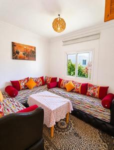 a living room with a couch and a table at Rayhane-26 in Al Ghar