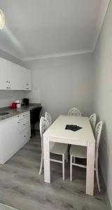 a white table and chairs in a kitchen at Hamsiköy Doruk Apart in Macka +5 photos