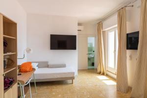 a bedroom with a bed and a table and a tv at Hotel Venere Azzurra in Lerici