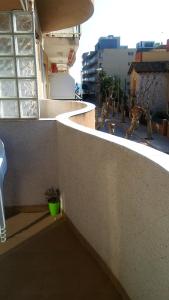 a balcony of a building with a green pot at Modern Apartment in Calafell + Terrace in Calafell