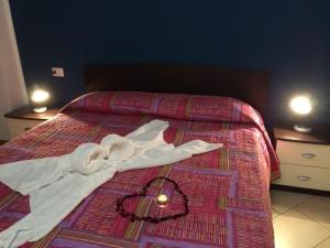 a robe laying on top of a bed at Lake View Apartment in Vercana, Shared Pool in Vercana