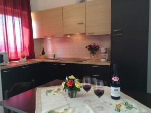 a kitchen with a table with two glasses of wine at Lake View Apartment in Vercana, Shared Pool in Vercana