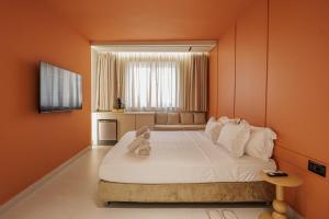 a bedroom with a bed with a teddy bear on it at Dreamscape Central in Tirana