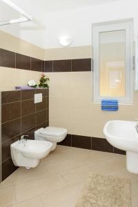 a bathroom with two toilets and a sink at Lake View Apartment in Vercana, Shared Pool in Vercana