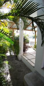 a white pergola with a view of a patio at Spacious Apartment in Pamplemousses with Private Pool in Pamplemousses Village