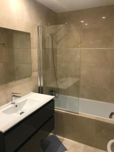 a bathroom with a sink and a shower at Spacious Apartment with Views in Málaga, 77 m², Shared Pool in San Luis de Sabinillas +14 photos