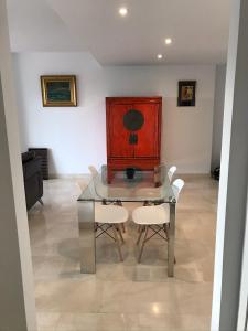 a dining room with a glass table and two chairs at Spacious Apartment with Views in Málaga, 77 m², Shared Pool in San Luis de Sabinillas