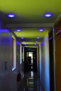 a hallway with blue and green lights on the ceiling at Modern Apartment with Garden and Lake View in Riambel in Riambel