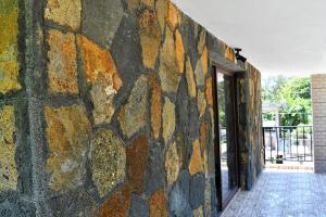 a stone wall in a building with a window at Modern Apartment with Garden and Lake View in Riambel in Riambel +11 photos