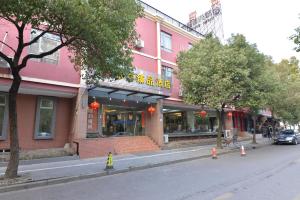a pink building on the side of a street at Irene Boutique Hotel - Jinshu Shop in Shanghai
