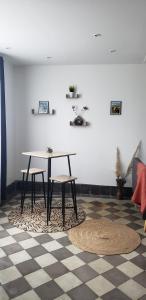 a table and two chairs in a living room at Studio - Le Saule in Foissiat