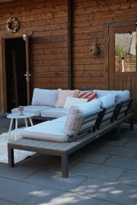 a couch sitting on a patio next to a table at Het Leendernest in Leende