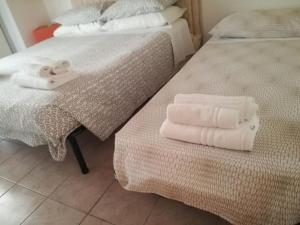 two folded towels are sitting on a bed at Comfortable Villa in Ragusa with Pool in Trecasuzze