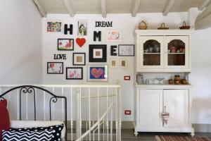 a nursery with a crib and a wall of pictures at Charming House in Trequanda with Shared Pool in Trequanda