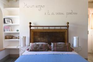 a bedroom with a bed with a quote on the wall at Charming House in Trequanda with Shared Pool in Trequanda