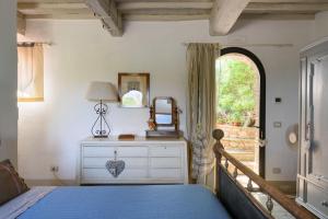 a bedroom with a bed with a dresser and a window at Charming House in Trequanda with Shared Pool in Trequanda +38 photos