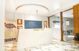 a reception area of a room with a reception counter at The Golden Plaza in Tarapith