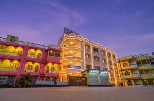a large white building with a lot of windows at The Golden Plaza in Tarapith