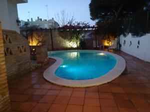 a swimming pool in a backyard at night at Charming Villa in Punta Umbría with Private Pool in Punta Umbría