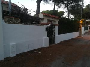 a white fence with a gate in front of a house at Charming Villa in Punta Umbría with Private Pool in Punta Umbría