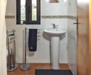 a white bathroom with a sink and a mirror at House with Shared Pool in Águeda, Mountain View in Urgueira