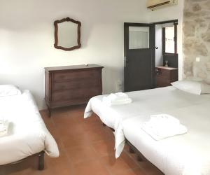 a bedroom with two beds and a dresser and a mirror at House with Shared Pool in Águeda, Mountain View in Urgueira