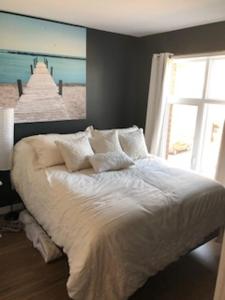 a bedroom with a bed with a view of the beach at Luxurious Apartment in Brossard with Terrace in Brossard