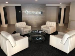a living room with white couches and a glass table at Luxurious Apartment in Brossard with Terrace in Brossard