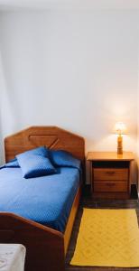 a bedroom with a bed and a table with a lamp at Charming House in Sistelo + View in Sistelo