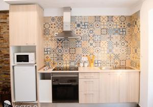 a kitchen with a stove and a microwave at Charming House in Sistelo + View in Sistelo