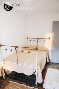 a bed in a room with a white wall at Charming House in Sistelo + View in Sistelo
