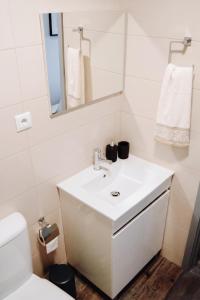 a bathroom with a white sink and a mirror at Charming House in Sistelo + View in Sistelo