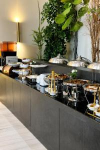 a buffet line with many plates of food at FLORA RUM LUXURY CAMP & Bubble Hotel in Wadi Rum