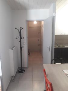 a room with a hallway with a table and a door at Appartement cosy avec piscine privée à Métabief - 38 m² in Métabief +12 photos