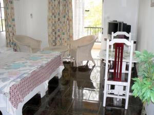 a room with a bed and a table and chairs at Cozy studio in Trou-aux-Biches 35 m² with lovely garden balcony in Trou aux Biches +33 photos