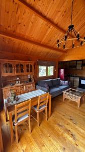 a living room with a table and a couch at Babia Góra View House in Kocierz Moszczanicki