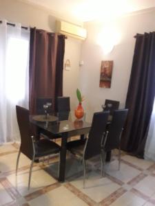 a dining room with a table and chairs at Modern Apartment in Melville, Pool View, 120 m² in Grande Gaube